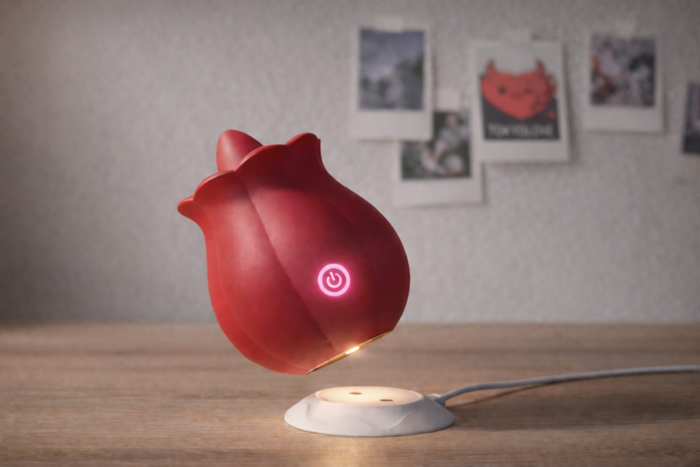 Rose Bliss personal massager shown suspended with magnetic charging connection, highlighting effortless recharging